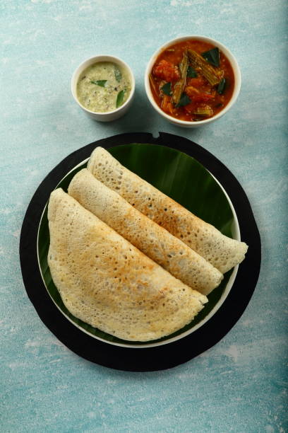 Healthy vegan diet- dosa with curry. Homemade delicious dosai with sambar and coconut chutney. thosai stock pictures, royalty-free photos & images