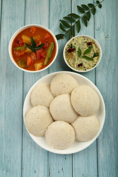 Steam cooked idly and sambar. Indian vegetarian foods - Fresh idli served with sambar and chutney. chutney stock pictures, royalty-free photos & images