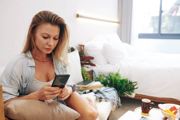 istock Pretty young woman texting 1303094824