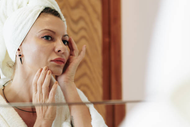 istock Woman applying moisturizing lotion 1303095344