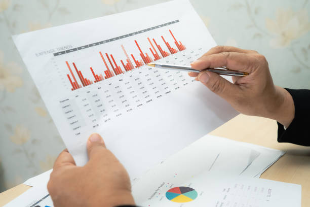 istock Asian accountant working and analyzing financial reports project accounting with chart graph and calculator in modern office, finance and business concept. 1303095533