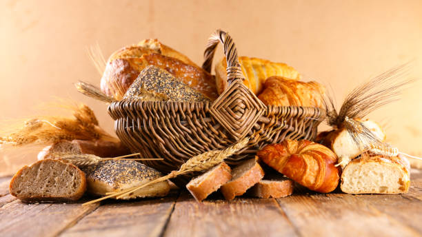 istock bread and croissant on wood background 1303097191