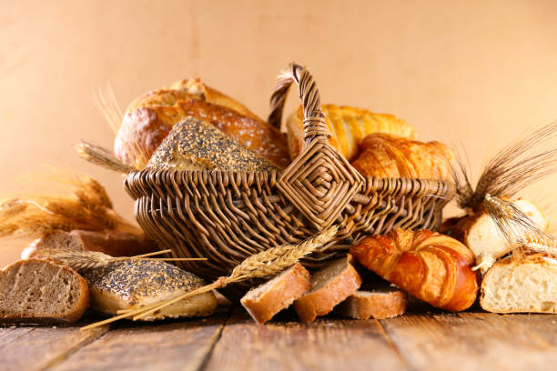 istock bread and croissant on wood background 1303097192