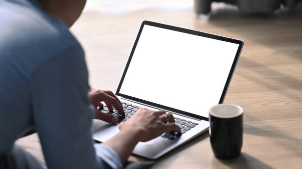 istock Young man lying on wooden floor and using computer laptop. 1303103125