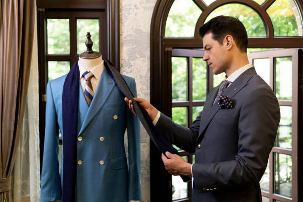 istock Man looking for new suit in costume store. 1303107019