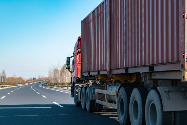istock Semi-trailer container cargo on the highway lane 1303107084