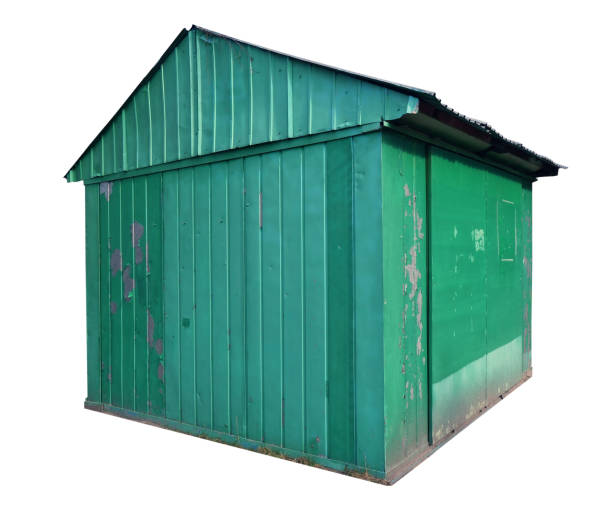 istock Small   aged green metal shed barn.  Isolated 1303108631
