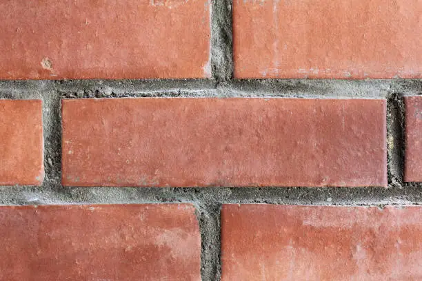 shabby red brick in masonry close-up