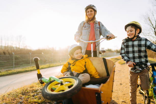 istock Two boys enjoy bike ride with their mom 1303109698