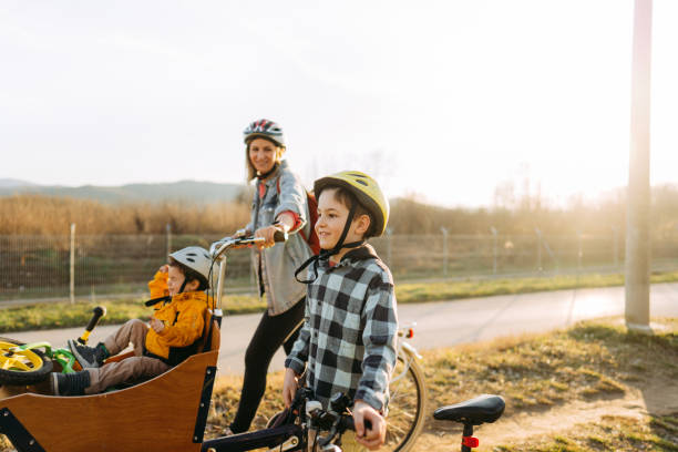 istock Two boys enjoy bike ride with their mom 1303109699