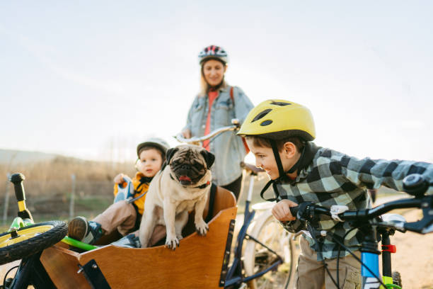 istock Two boys enjoy bike ride with their mom 1303109736