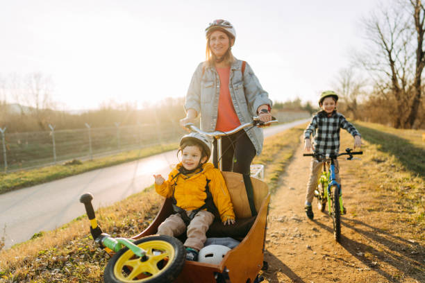 istock Two boys enjoy bike ride with their mom 1303109741