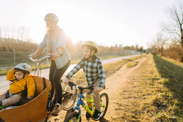 istock Two boys enjoy bike ride with their mom 1303109813