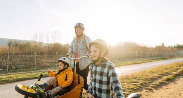 istock Two boys enjoy bike ride with their mom 1303109942