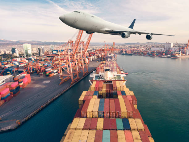 istock Airplane flying above the container ship. Transportation concept. 1303110545