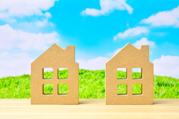istock Miniature houses and blue sky 1303110566