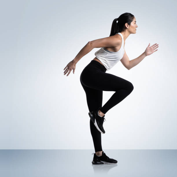 istock Athletic woman running pose 1303110579