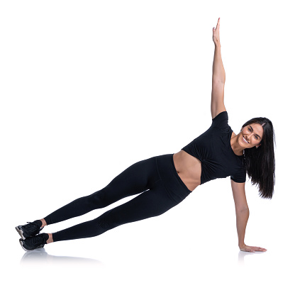 Athletic woman in sportswear doing one hand side push ups