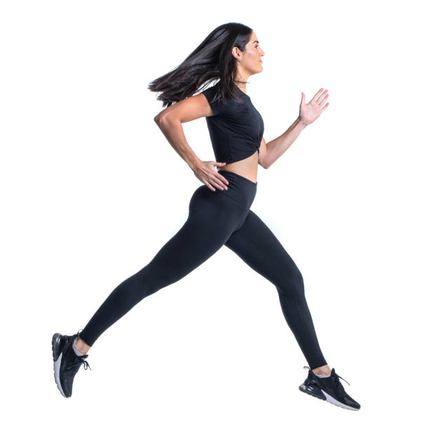 istock Athletic sprinter woman dress in black running on white backdrop 1303110586
