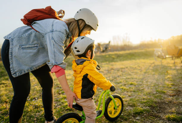 istock Little boy's learning to ride a bicycle 1303110647