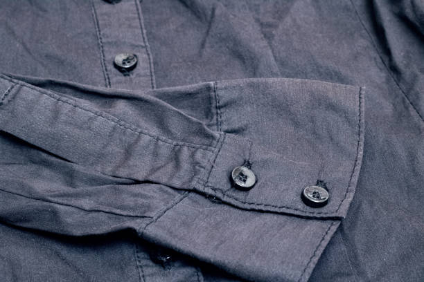 istock Buttons on a black shirt close up 1303110802