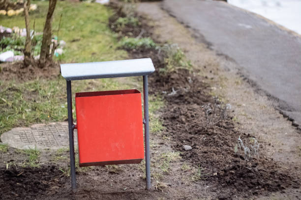 istock Red metal litter bin on the sidewalk 1303110906