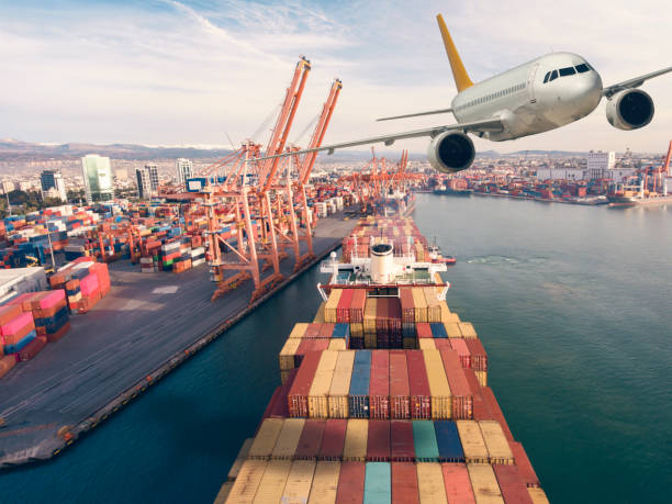 istock Airplane flying above the container ship. Transportation concept. 1303110919