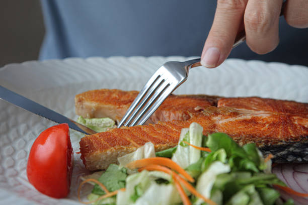 istock Fried steak of red fish salmon with herbs. 1303111652