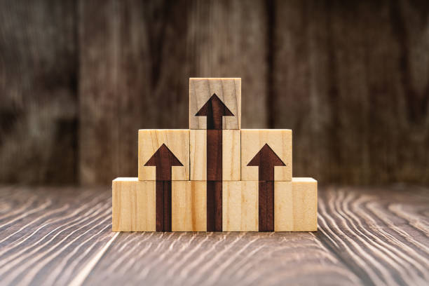 istock Arrows Pointing Up on Stack of Wooden Blocks 1303112782