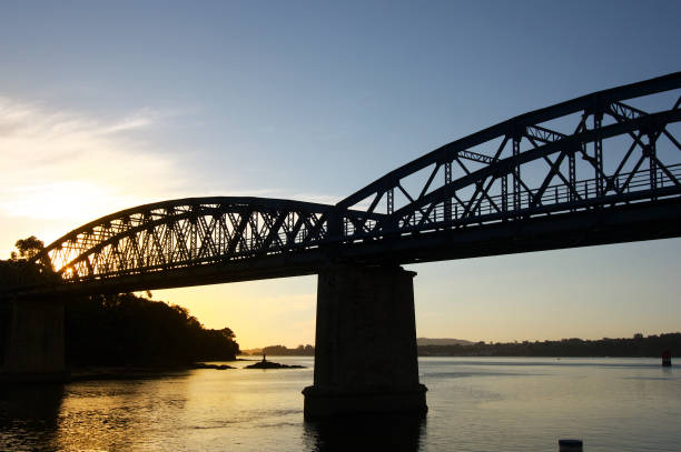 istock Pontedeume railway bridge back lit at dusk. 1303114503