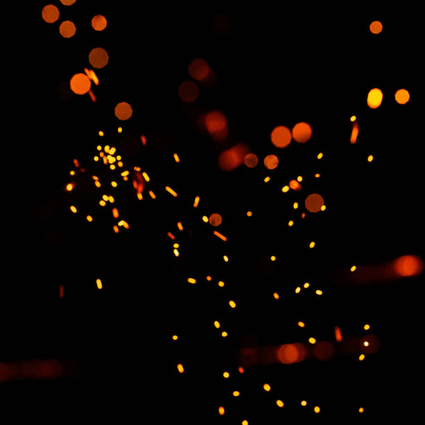 istock Bright yellow sparks on a black background, yellow bright round bokeh. 1303115294