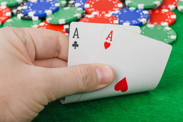 istock Hand with playing cards in casino 1303115764