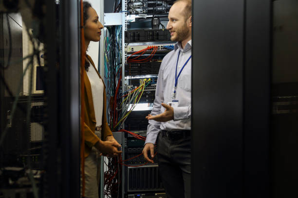 istock IT professionals having meeting in server room 1303116628
