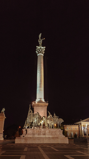 Leipzig, Germany - July 02, 2022: The Nikolai pillar at the Nikolai square. Built in view of its importance in the 1989 peaceful revolution. The monument illuminated at night. After dawn in Leipzig