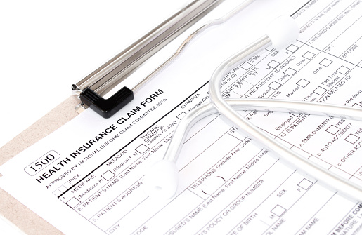 Health Insurance Claim Form. Individual medical health insurance policy with stethoscope