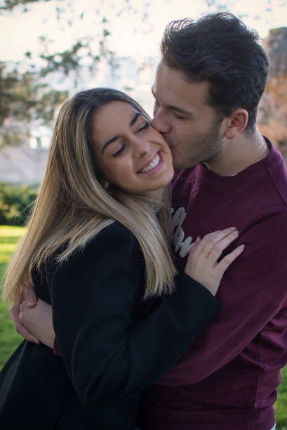 istock Lovers Kissing Outdoors In The Park. 1303122368