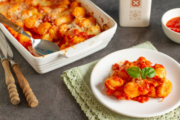 Home made baked italian gnocchi with tomato sauce and parmesan cheese stock photo