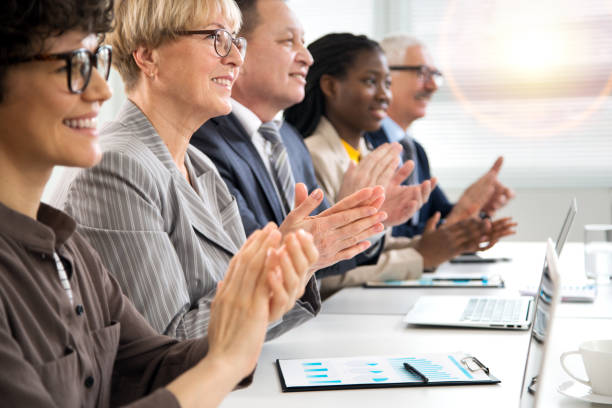 istock Business people clapping hands at business seminar. 1303124750
