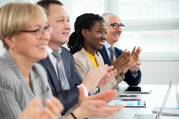istock Business people clapping hands at business seminar. 1303124821