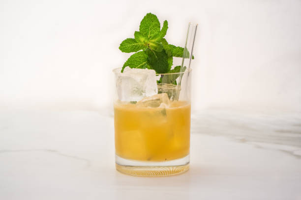 Mai Tai cocktail Garnished with a Sprig of Mint Mai Tai Cocktail and Tiki Drink Garnished with a Sprig of Mint on White Background mai tai stock pictures, royalty-free photos & images