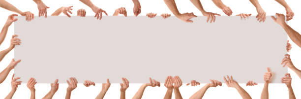 Many hands in different positions holding a poster Many hands in different positions holding a poster with white isolated background. Panoramic composition positioning stock pictures, royalty-free photos & images