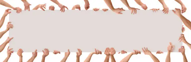 Many hands in different positions holding a poster with white isolated background. Panoramic composition