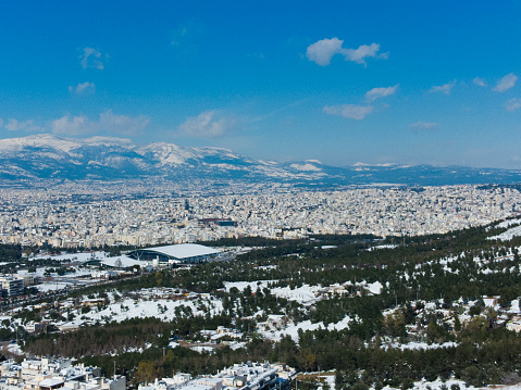 Aerial view of snowy buildings during the Medea snowstorm in Athens, Galatsi