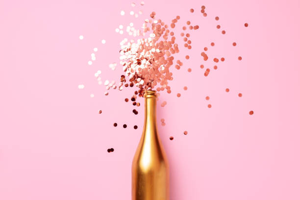 istock Champagne bottle with confetti flat lay top view 1303130819