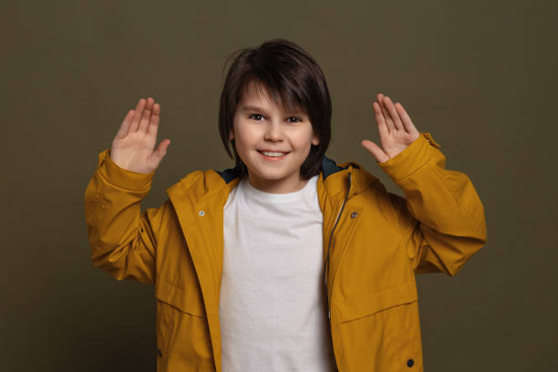 istock Emotional little boy express overjoy and surprised, spread hands sideways and smiling, showing astonishment and shock 1303132767