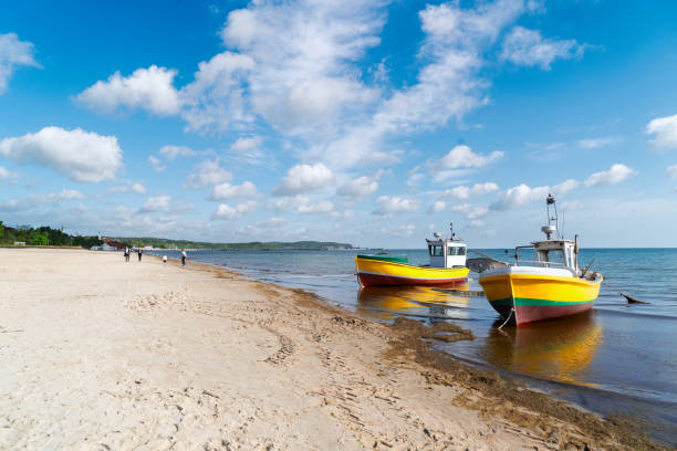 traditional fishing boats and long white sand beach of Sopot, Poland