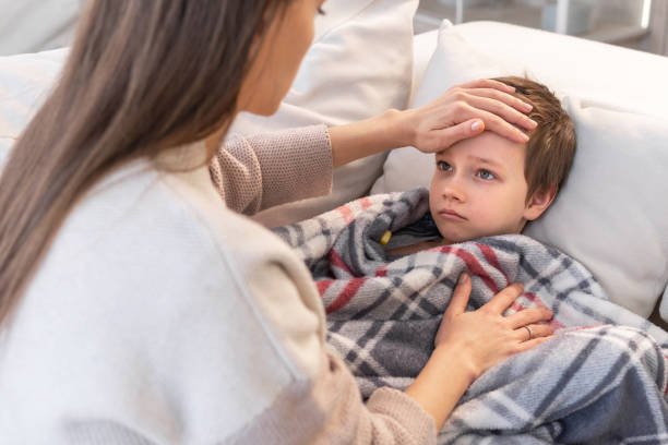 istock Mother is taking temperature of her son 1303133539