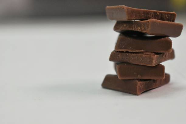 istock A stack of choclate bars packed as a gift on a black background and copy space 1303135588