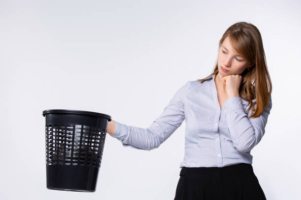 istock Sad volunteer picking garbage. Woman with trash bin, dreams about recycling concept. Waste reducing, volunteering concept for banner, website design or landing web page 1303138086