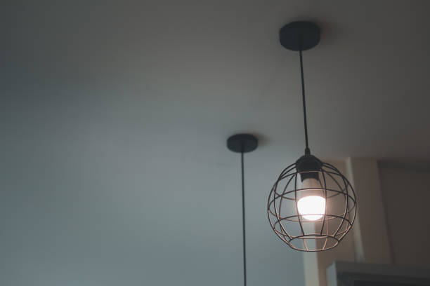 istock Modern pendant light with vintage light bulb decoration in home 1303138094